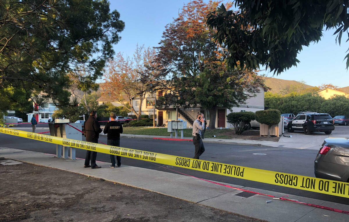 Police tape marks the site of a shooting Monday in San Luis Obispo. Two officers were shot, and the suspect is dead.