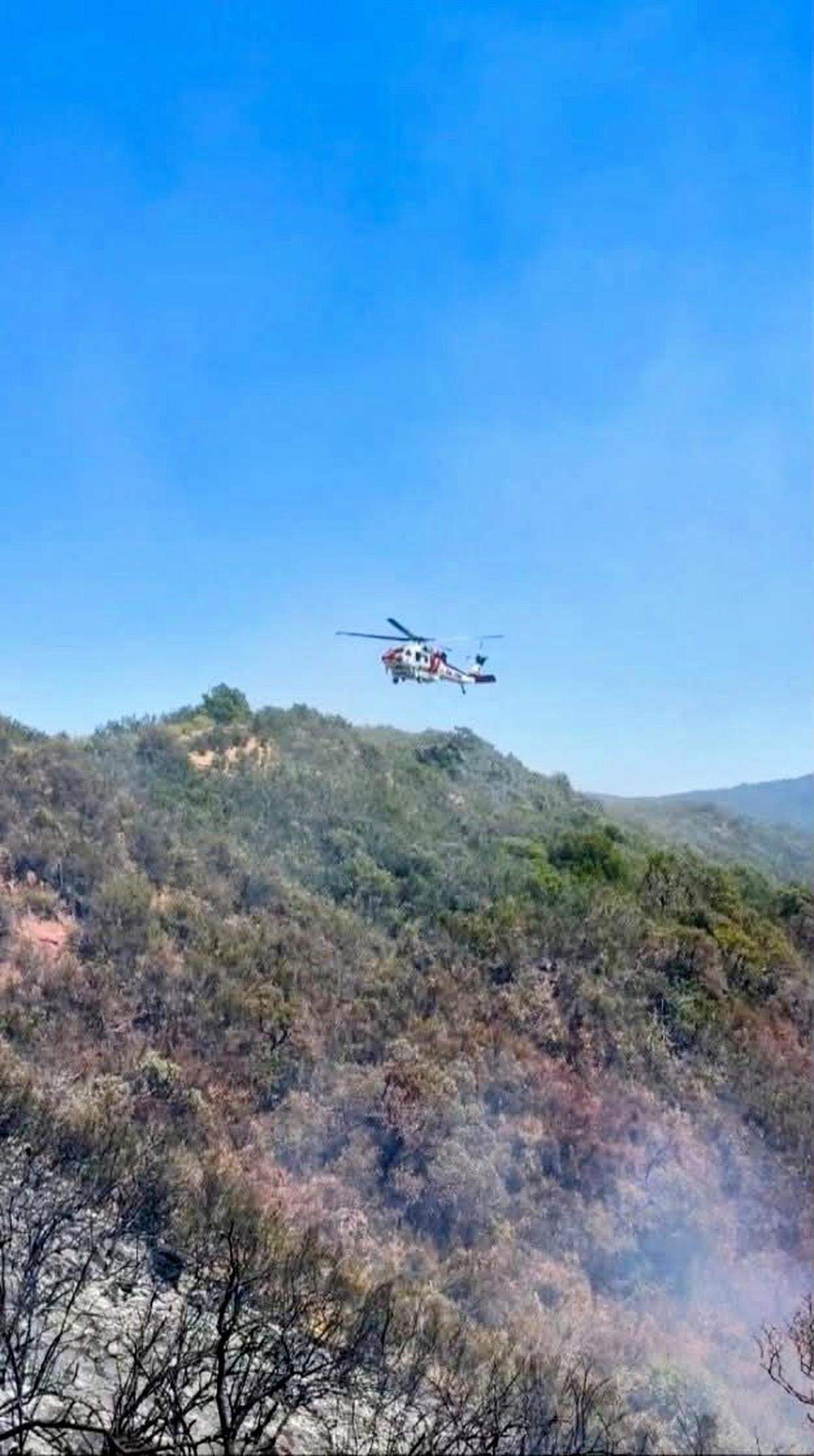 A firefighting helicopter responds to the Rock Fire west of Paso Robles on Sunday, May 10, 2026.