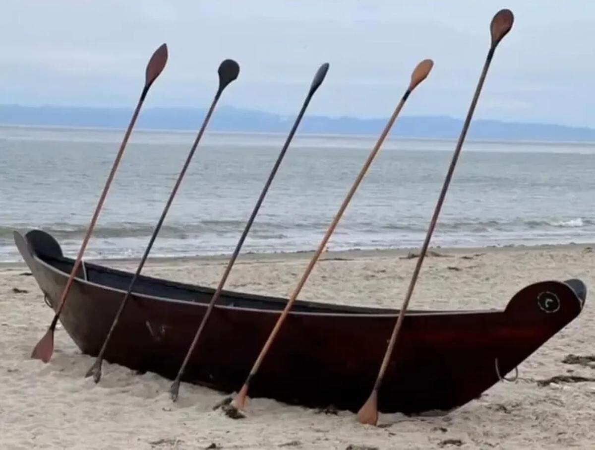 A 25-foot-long and 700-pound wooden Chumash tomol that has gone missing in Santa Barbara usually sits on West Beach near the outriggers. The canoe vessel is used daily for educational and fishing activities.