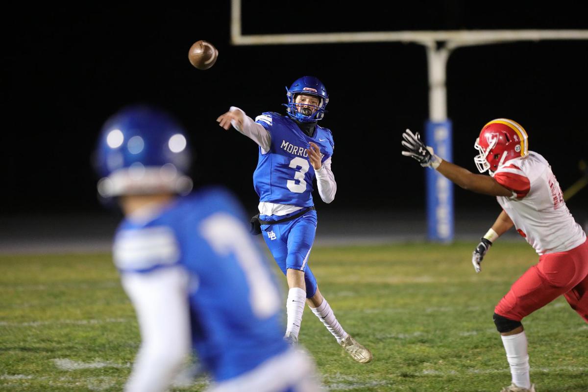 Nicky Johnson throws a pass after scrambled to elude defenders in Morro Bay’s 35-27 win over Loara High of Anaheim in a state playoff game, Dec. 3, 2021.