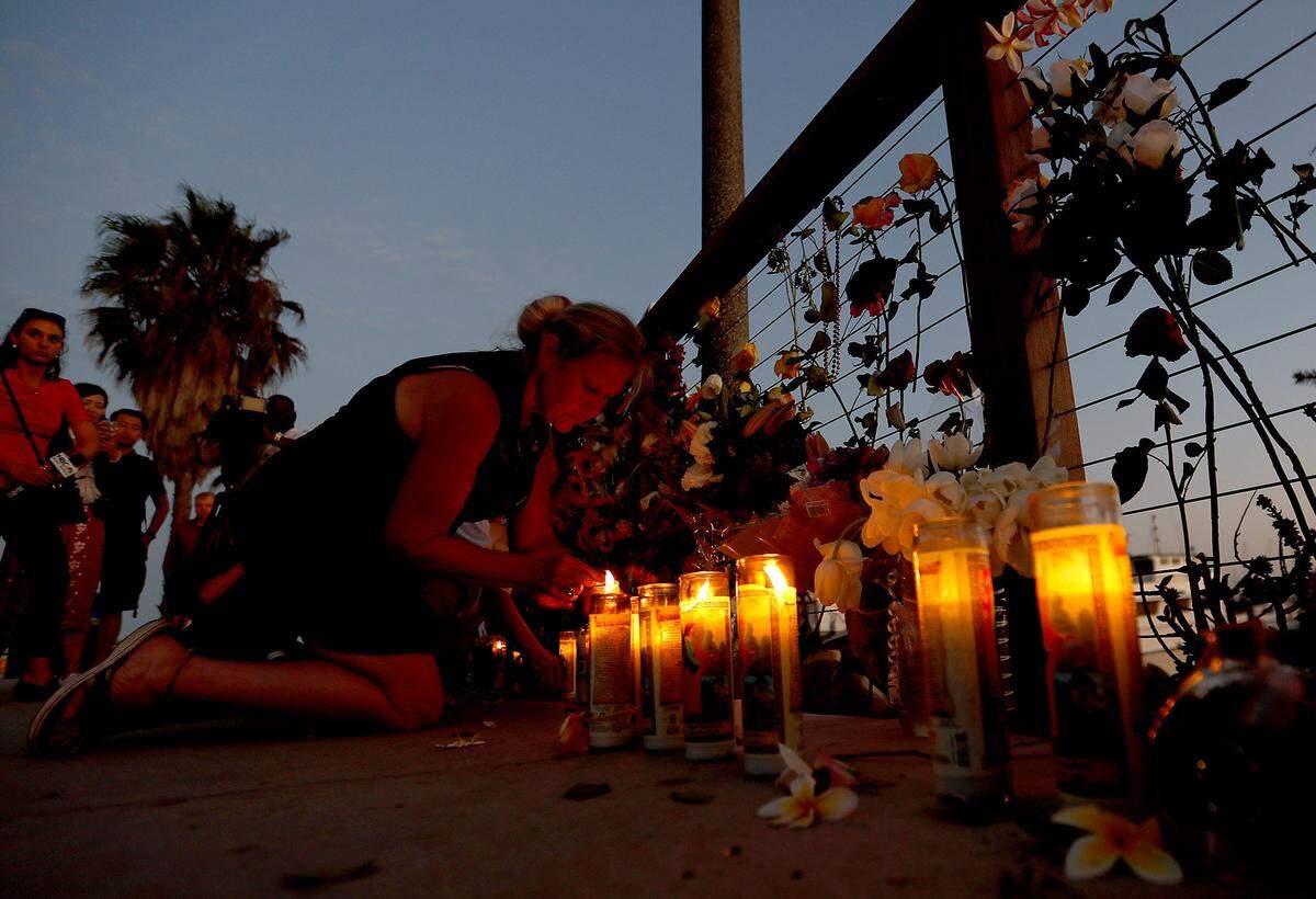 People pause on Tuesday, Sept. 3, 2019, to pay their respects at a makeshift memorial in Santa Barbara, Calif., for victims of a deadly fire aboard a dive boat a day earlier. The fire broke out on the 75-foot dive boat Conception early Monday morning as the victims slept below decks. (Luis Sinco/Los Angeles Times/TNS)