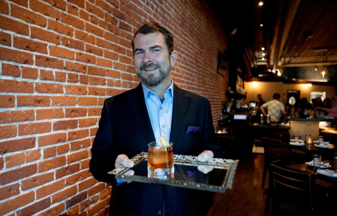 La Cosecha’s general manager Ben Meyer holds a specialty cocktail on a mirrored tray. The restaurant in downtown Paso Robles recently had a change of ownership and has a new menu featuring Spanish and Peruvian food.