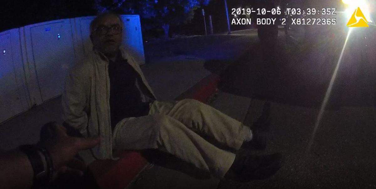Former Cal Poly materials engineering lecturer Sarder Sadique sits handcuffed on a sidewalk during an Oct. 5, 2019, on-campus traffic stop by University police officers. The screenshot is from officer body camera footage.