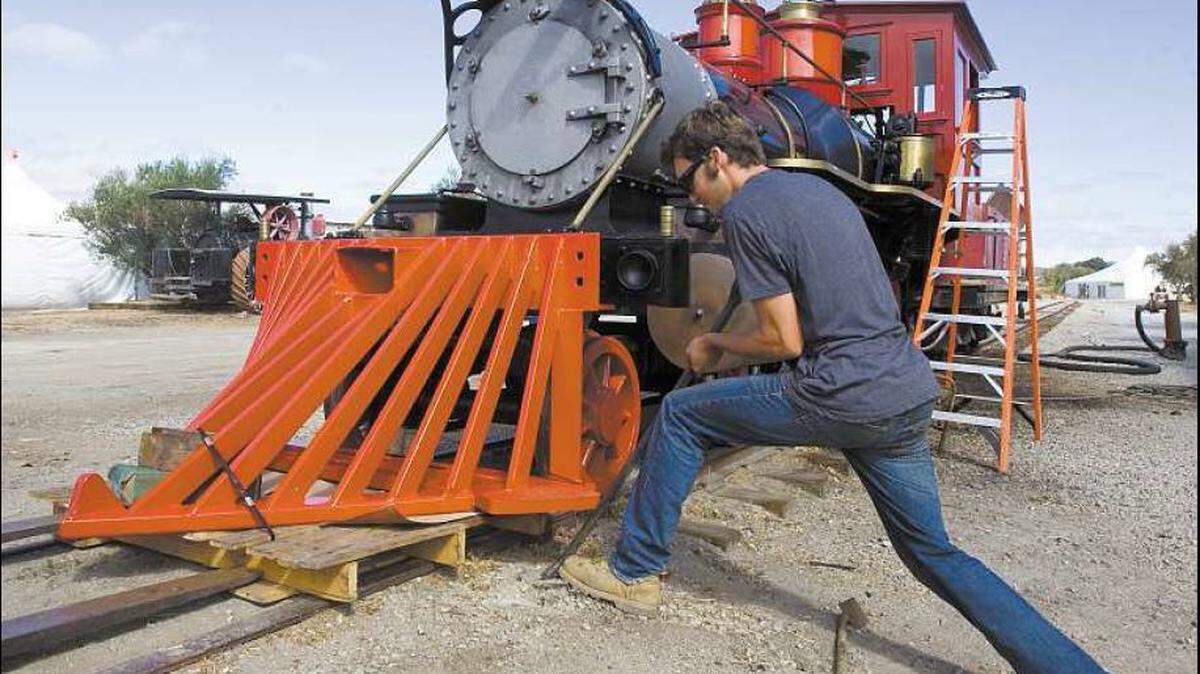 Jeff Tolan installs the pilot (also called the “cow catcher”) on the front of the engine Thursday at the Santa Margarita Ranch.