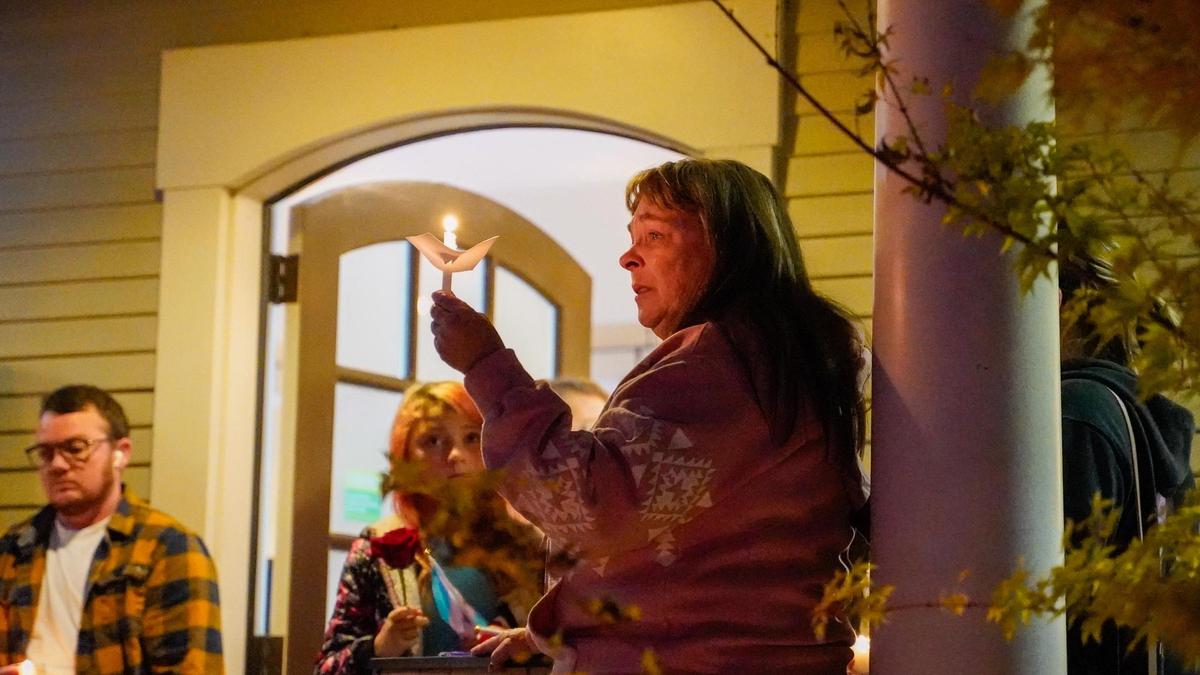 Melody Pinion raises a candle at a vigil hosted by the Gala Pride & Diversity Center in memory of her son Todd Joseph Pinion, an Atascadero resident who was killed in an alleged hate crime, Nov. 22, 2024.