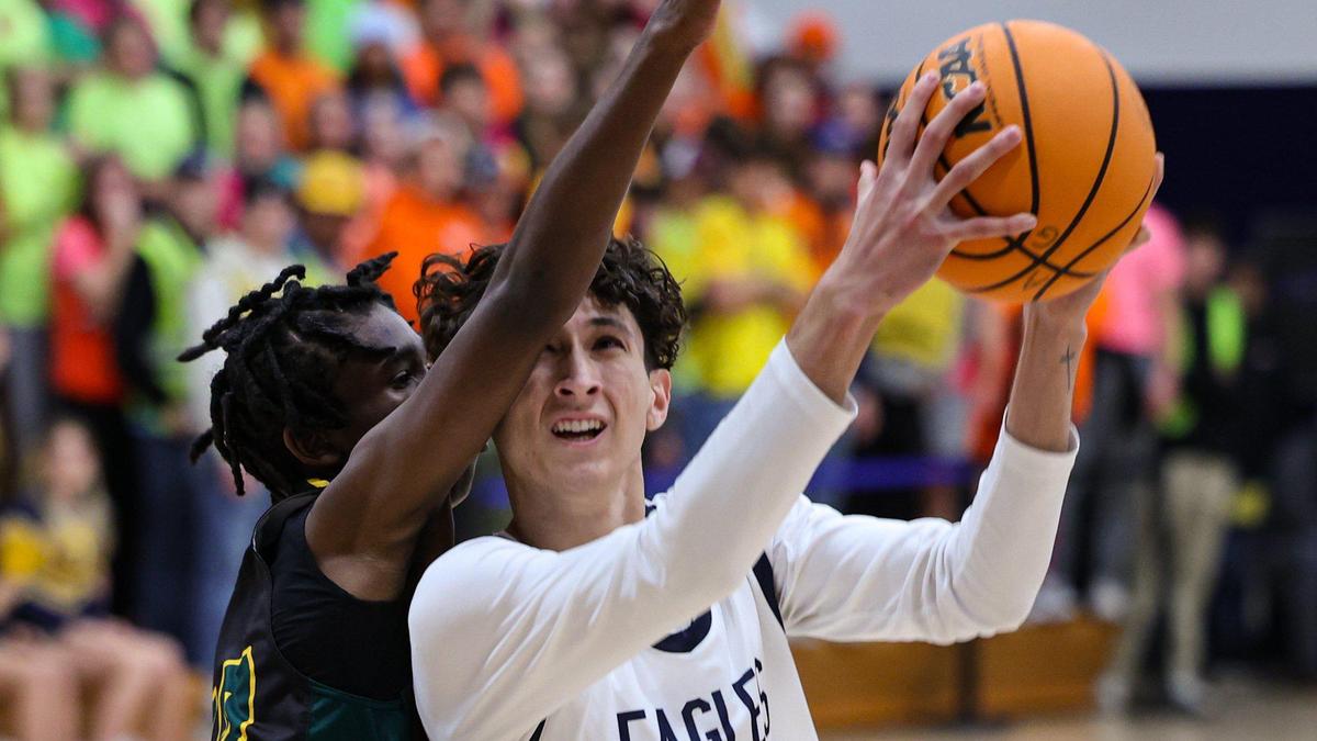 Aiden Peralta goes to the rim while Tarynce Price contests the shot. Arroyo Grande fell 76-62 to Blair in the first round of 2023 Division 4 CIF State Boys Basketball Championships on Feb. 28, 2023.