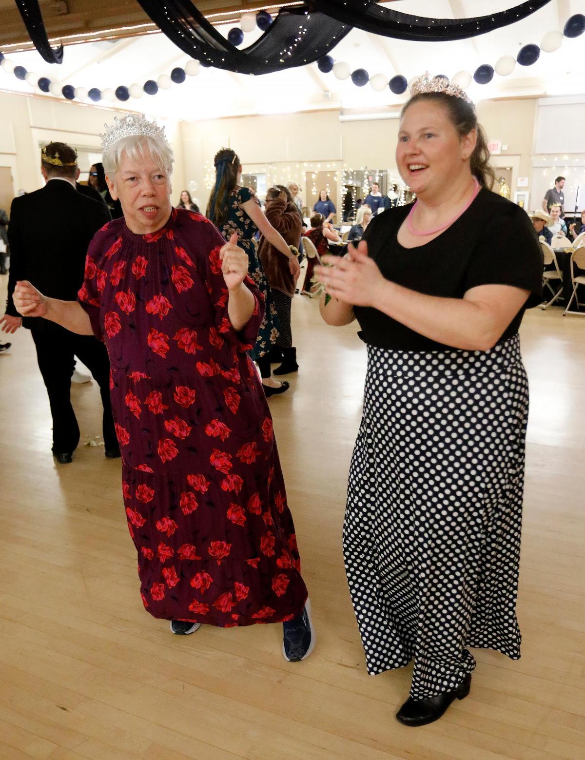 Alison Reisig, left, dances with a friend at the “Let Your Light Shine” Special Education Prom in Atascadero on Friday, March 7, 2025. This special education event aims to provide a night of fun, joy, and celebration for individuals with disabilities, giving them the opportunity to enjoy the prom experience in an accessible and supportive environment.