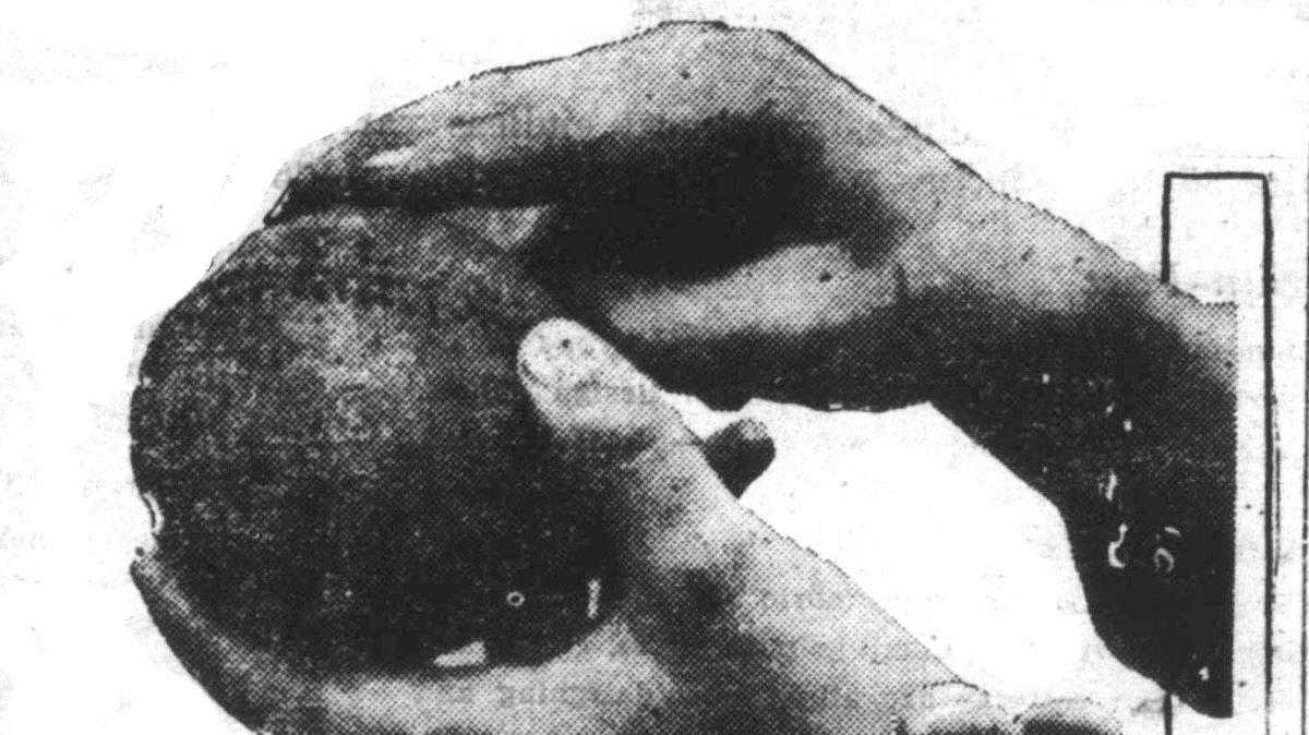 Moisten the plain surface on top of the ball (Top Fig.). You must get a lot of speed on this one. Eleventh of a series of photos, posed especially by Joe Tinker, Jr., for The Daily Telegram, on how to play baseball.