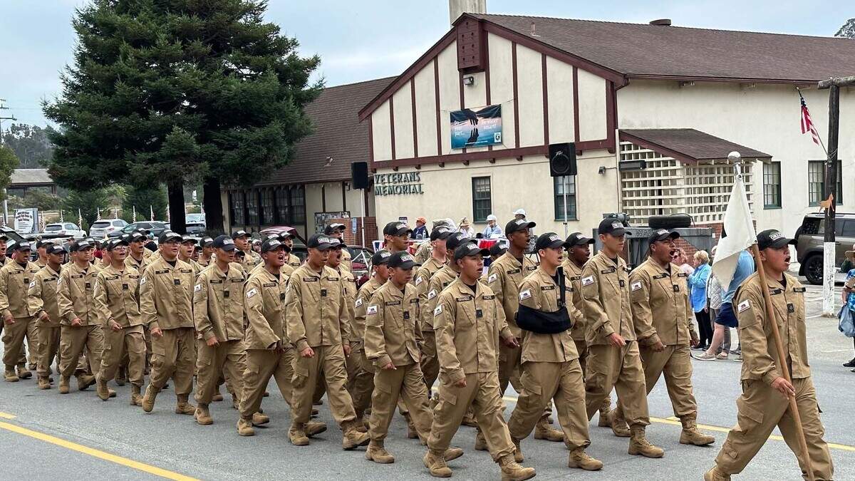 A troupe of Grizzly Youth Academy students march past the Cambria Veterans Memorial Building during the 2023 Pinedorado parade, an annual event attended by thousands of visitors and San Luis Obispo County residents. The 1949 structure has been a hub for a wide variety of heavily attended community events in the small coastal village.