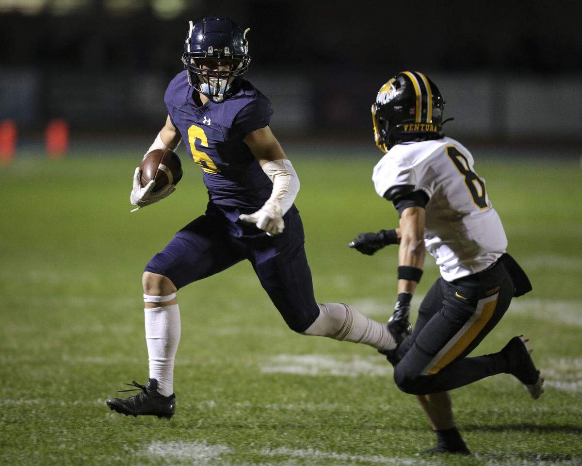 Nathan Swaim pursued by Myles Russell.Ventura beat Arroyo Grande 35-28 in a high school state football championship semi-final on Dec. 5, 2025.