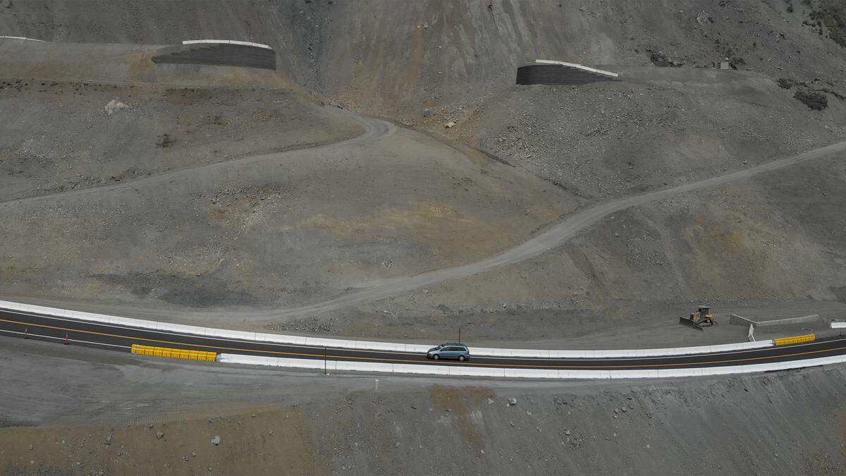 The first cars drive along the newly opened section of Highway 1 across the Mud Creek Slide on the Big Sur coast in July 2018.