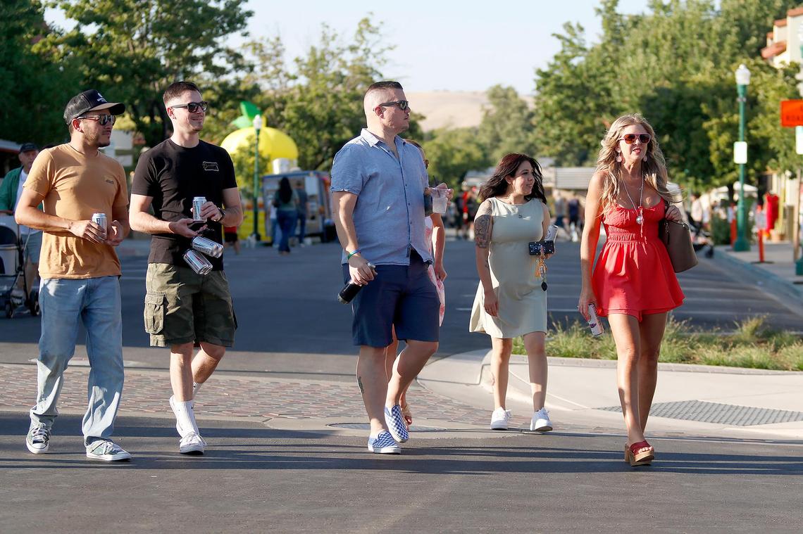People enjoy a block party after a ribbon-cutting ceremony held Friday, June 27, 2025. Atascadero, California, completed its downtown makeover on El Camino Real with new parking, lights and greenery.