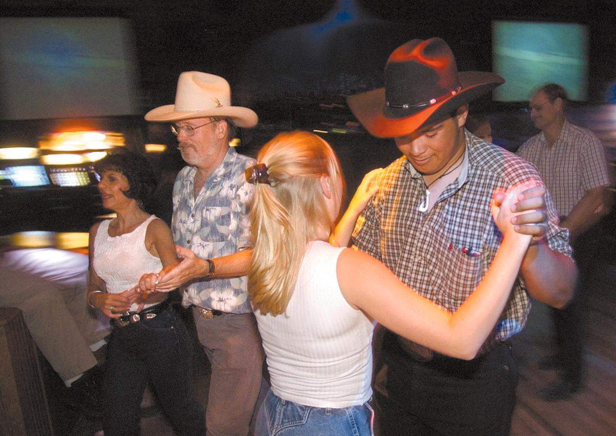 At right, Keone Calderon dances with Julia Renfro at The Graduate Restaurant & Nightclub in San Luis Obispo in 2003. In the background are Randy Freeman and Katie Stasinas. The establishment closed in 2020.
