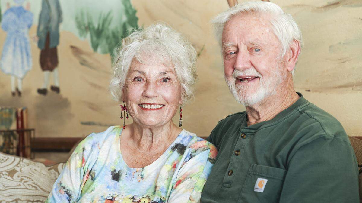 Luana Herlihy credits her husband Jack for being supportive as their family grew to 19 children, seen here at their Los Berros area home on May 6, 2026. The mural behind them is based on a European mural and includes all the children, it was painted by one of their sons.