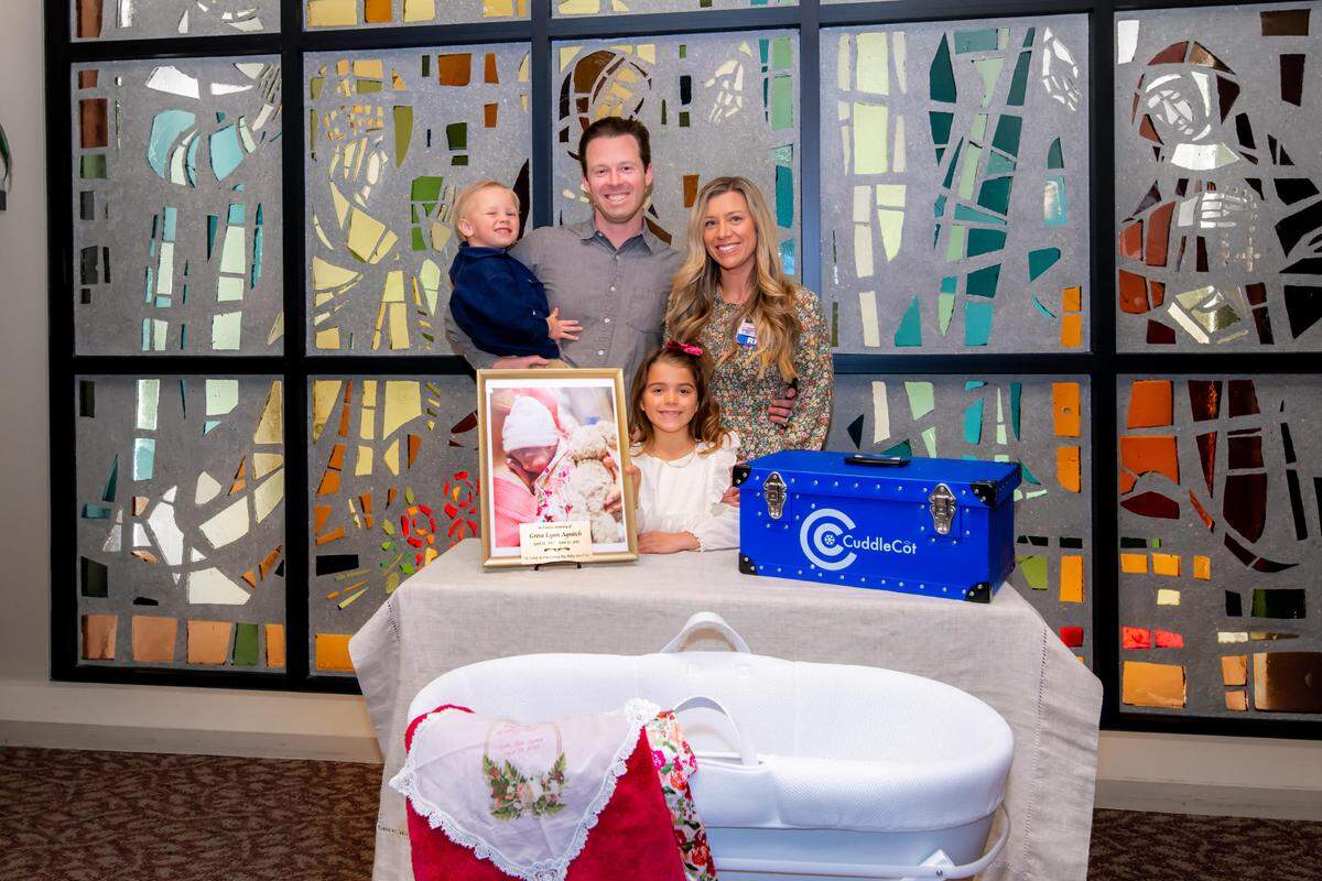 The Agnitch family gifts a CuddleCot, a cooling bassinet, to Marian Regional Medical Center, in memory of their deceased daughter, Greta Agnitch.
