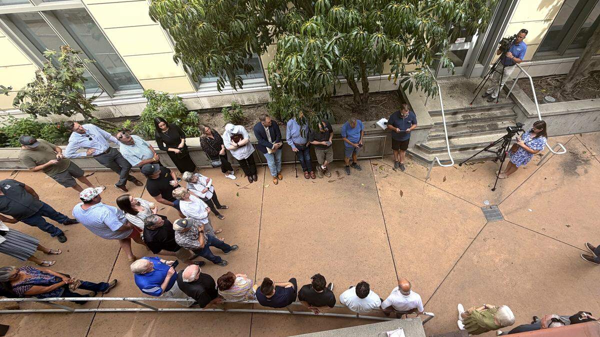 A crowd of roughly 43 people gathered in the breezeway and balconies at the SLO County Central Services Building at 1087 Santa Rosa St. in downtown San Luis Obispo to witness the auction of the F. McLintocks Saloon and Dining House building on March 24, 2026.