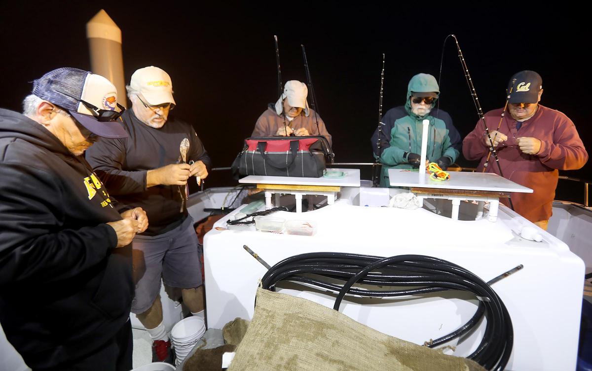 Volunteer fishing prepare their poles early Friday morning before departing Morro Bay on Aug. 2, 2019, on a California Collaborative Fisheries Research Program trip to conduct research on the Central Coast fish population.