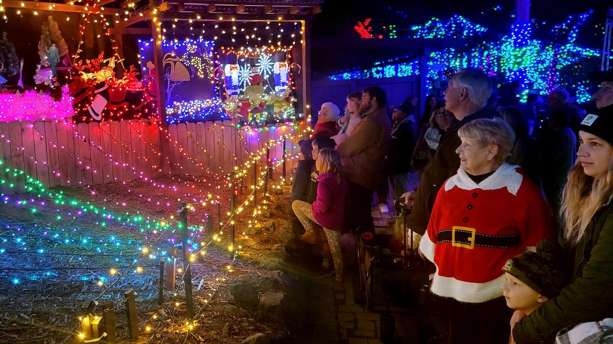 Los Osos resident Judy Hardy, wearing a Santa sweater, and Morro Bay resident Melodie French, right, enjoy the 12 Days of Christmas lighted display at the Cambria Christmas Market on Wednesday, Dec. 14, 2022.
