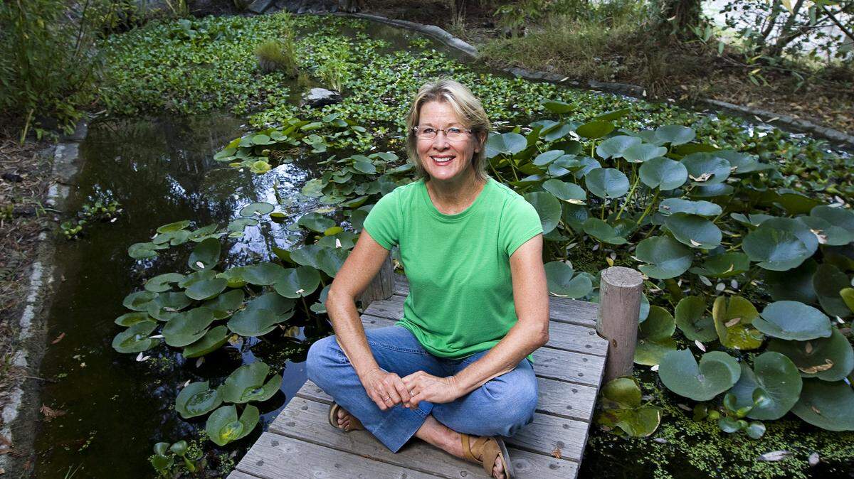 Author Paula Huston poses at her Arroyo Grande home, where she and her husband make wine, press olive oil and raise bees and chickens.