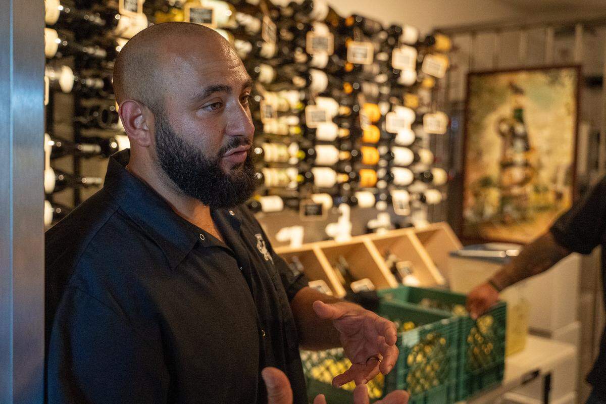 Giuseppe's Italian American Club manager Aurash Afshar stands in the old bank safe that now serves as the restaurant's wine storage on Tuesday, May 19, 2026. The deli and restaurant expansion of the existing Giuseppe's Cucina Italiana in Pismo Beach recently started its own offshoot brand of limoncello.
