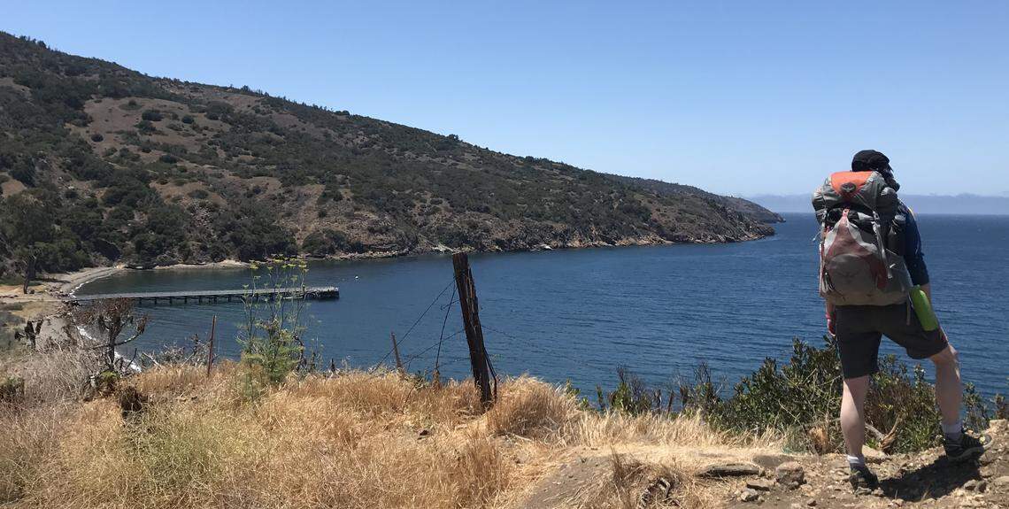 Michael Light takes a pause from his hike up Del Norte Trail to view Prisoners Harbor on Santa Cruz Island Juy 13, 2018.