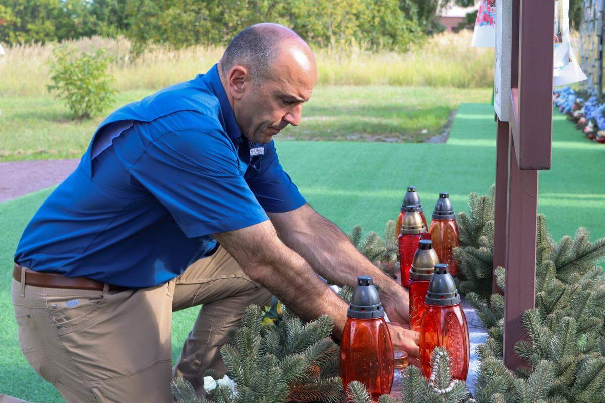 Congressman Panetta lays a candle at Saint Andrews Church in Bucha, where Ukrainian civilians murdered by Russian forces are buried.