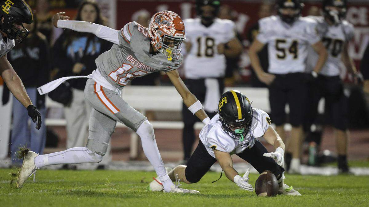Ethan Asmus Guilford dives for the ball on a short kickoff getting to the ground before Colby Cooper.  San Luis Obispo beat Atascadero 28-14 in high school football on Oct. 31, 2025.