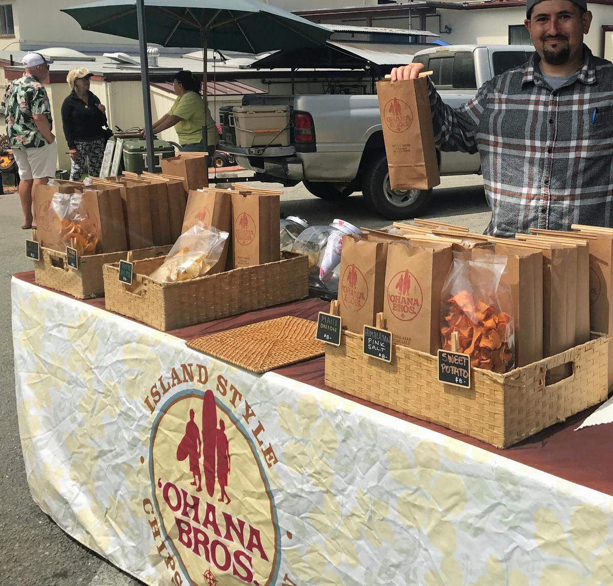 Ethan Gonsalves sells gourmet potato chips at the Ohana Bros. Snack Company stall at the Cambria farmers market.