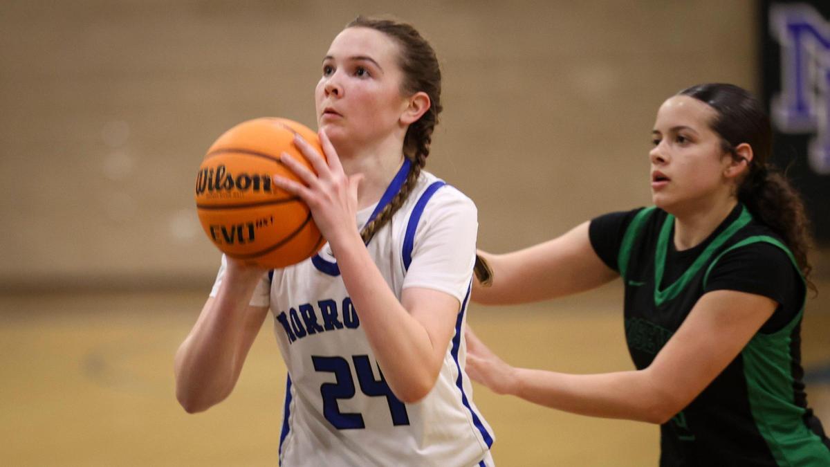 Violet Pace shoots pursued by Auburn Santos. Morro Bay beat Roosevelt 39-24 in the CIF Central Section Division 3 girls basketball semifinals on Wednesday, Feb. 21, 2024.