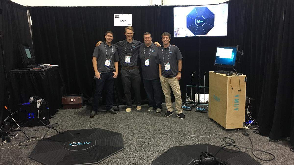 The VMUV team standing in front of the Motus Platform. VMUV is bringing immersive and fluid movement to VR and is showcasing several games in a demo Sunday at Bristol Cider House.