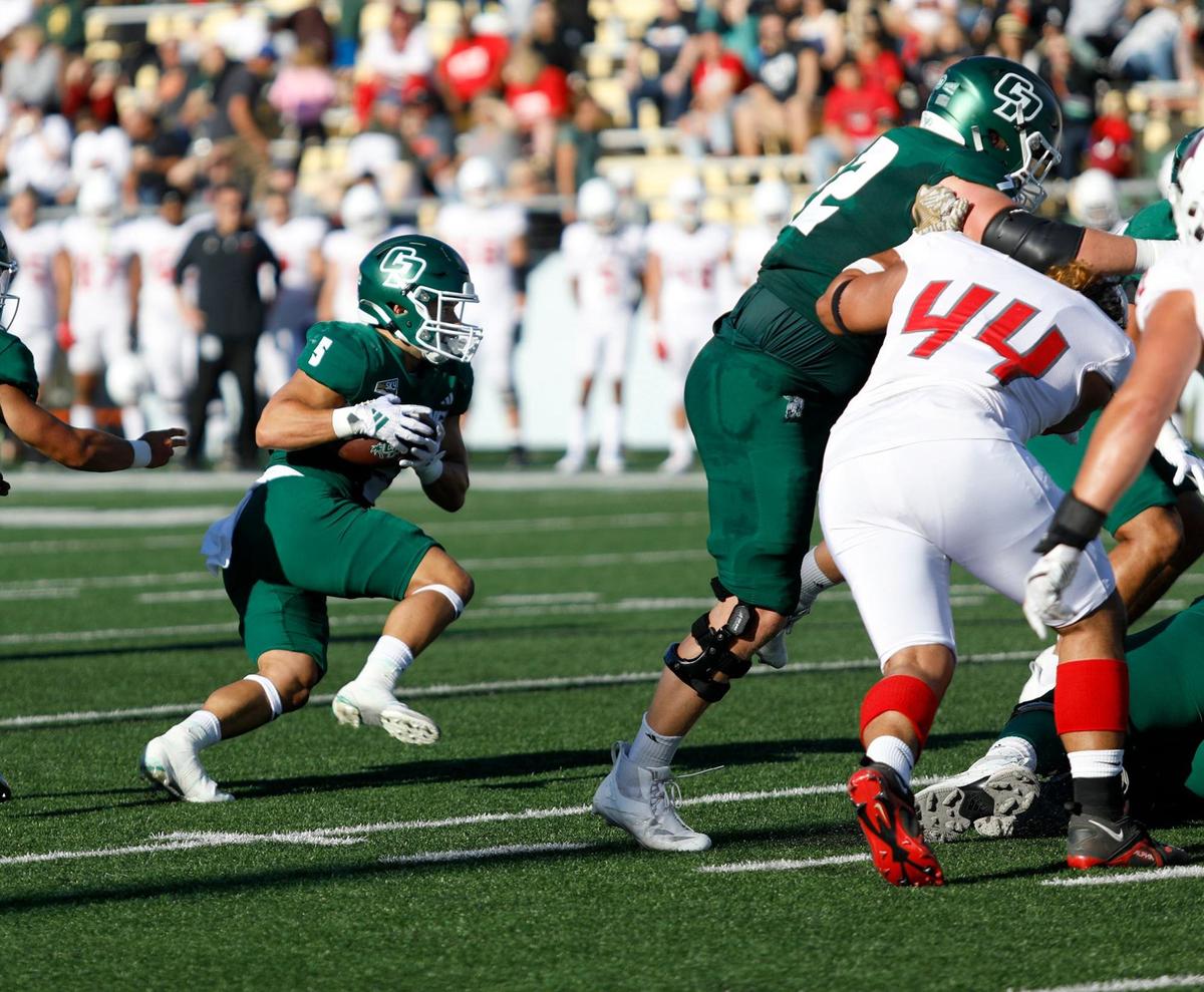 Cal Poly’s Aiden Ramos looks for an opening in Cal Poly’s 31-14 win over Western Oregon in a college football game on Sept. 14 2024, in San Luis Obispo.
