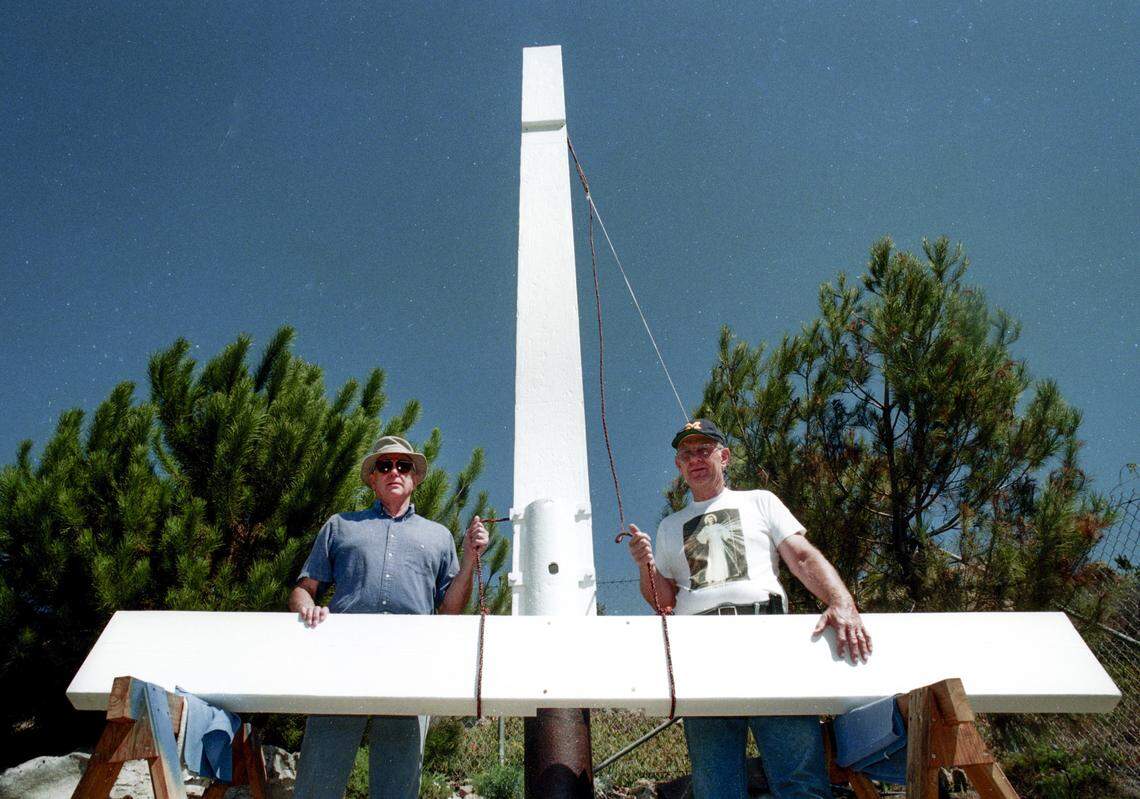 Ken Barwell, left, and Jim Snead stand by the cross Sept. 11, 1997. They rededicated it in Pismo Beach on private property after it was removed from Boosinger Park earlier in the year after an objection was lodged with the city.