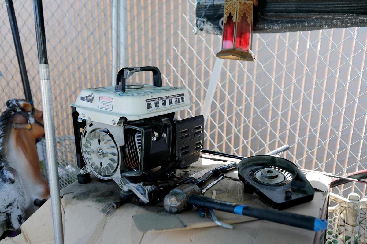 A dismantled generator sits in an area Juan Mejia use to work on repair projects at the Oklahoma Avenue Safe Parking Site.