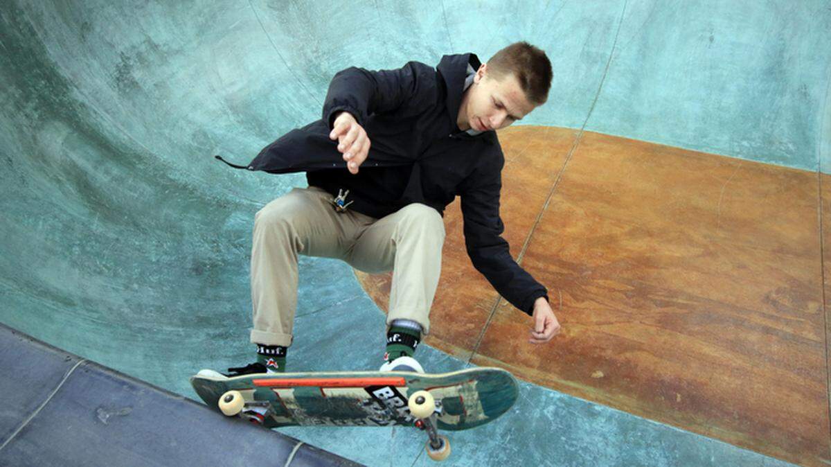 Ty Hjortland, 19, San Luis Obispo executes a rail slide along the edge of the deepest pool at the new San Luis Obispo Skate Park on Saturday.