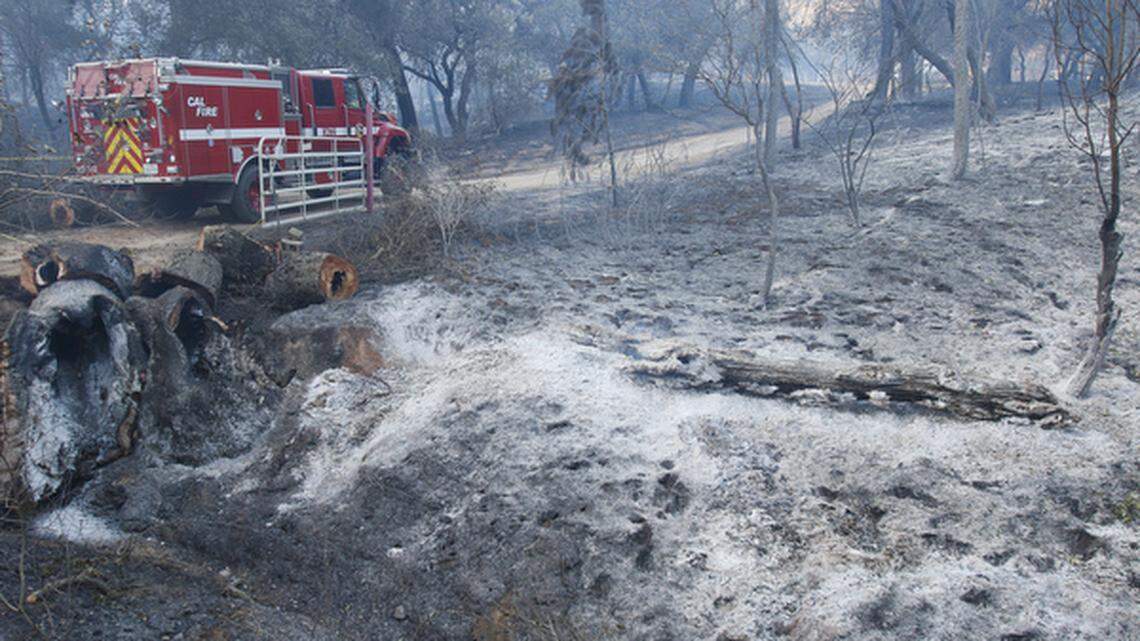 A Cal Fire truck goes up the driveway to a home on Las Pilitas Road on Sunday morning.