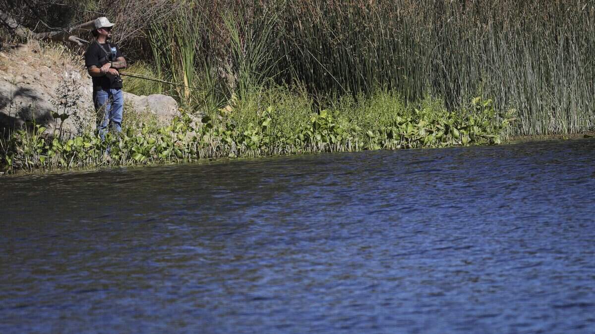 James Valdez fishes from the banks of Santa Margarita Lake on Sept. 2, 2026. A new law allows body contact with the water at Santa Margarita Lake starting in January, but the details have yet to be worked out with San Luis Obispo County.