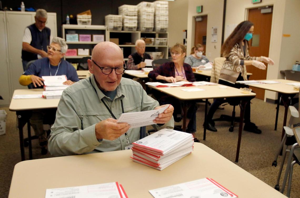 Buzz Kalkowski and other San Luis Obispo County Elections Office workers process vote-by-mail ballots on Nov. 9, 2022, the day after the vote. The Elections Office will conduct a manual recount of the San Luis Obispo County Board of Supervisors District 2 race on Monday, Dec. 19, 2022.