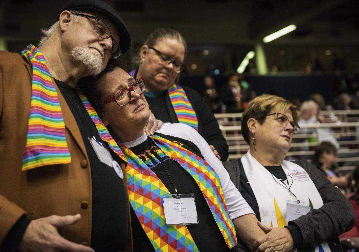 Ed Rowe, left, Rebecca Wilson, Robin Hager and Jill Zundel react to the defeat of a proposal that would allow LGBT clergy and same-sex marriage within the United Methodist Church at the denomination’s 2019 Special Session of the General Conference in St. Louis, Mo., Tuesday, Feb. 26, 2019. America’s second-largest Protestant denomination faces a likely fracture as delegates at the crucial meeting move to strengthen bans on same-sex marriage and ordination of LGBT clergy.