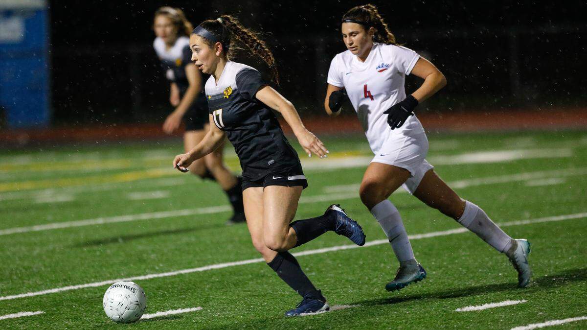 SLO High’s Olivia Ortiz runs ahead of Buchanan’s Gianna Chiaramonte in a CIF-Central Section girls soccer quarterfinal playoff game Friday night at Pioneer Valley High School.