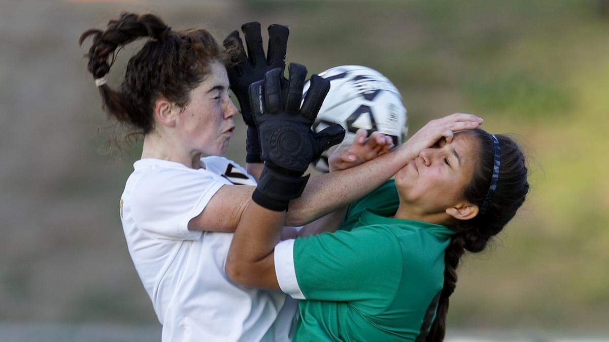 Frankie Phelan of San Luis Obispo High put the ball in the net but it was called back for interference with the Sunny Hills keeper Priscilla Avila.