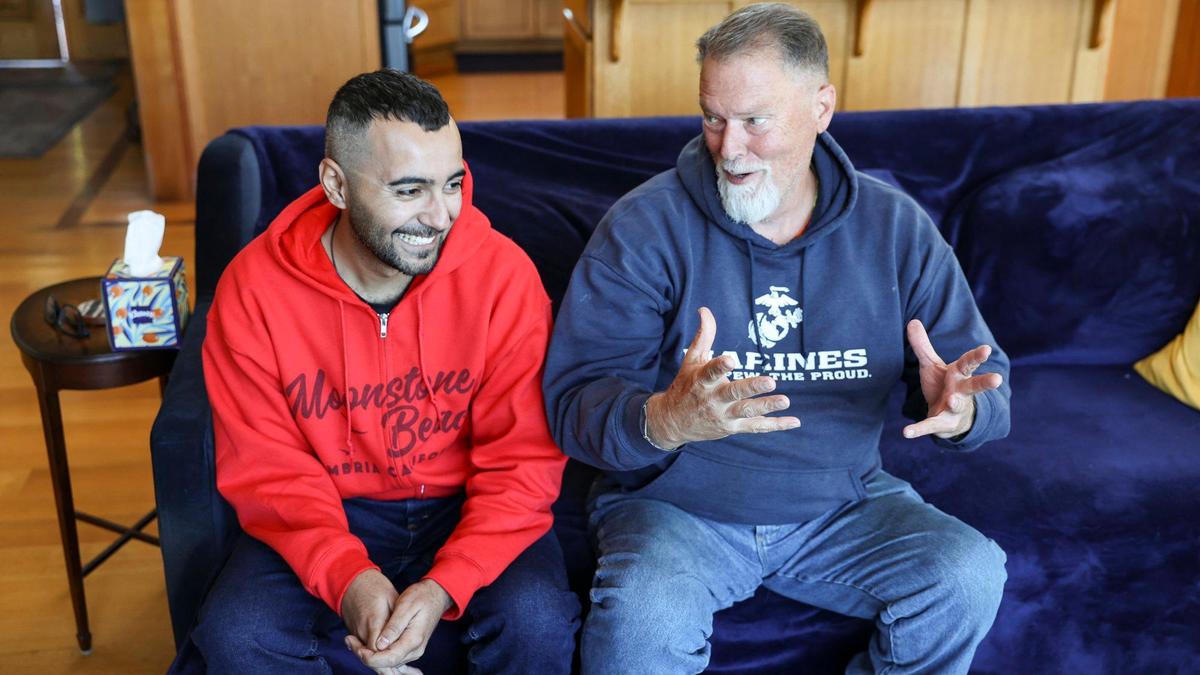 Ali Al-Shammari, left, and Michael Reeves share stories of their interactions in Iraq where they met. Reeves is sponsoring Al-Shammari after he walked from Brazil to the United States seeking asylum. Seen here on Oct. 15, 2024.