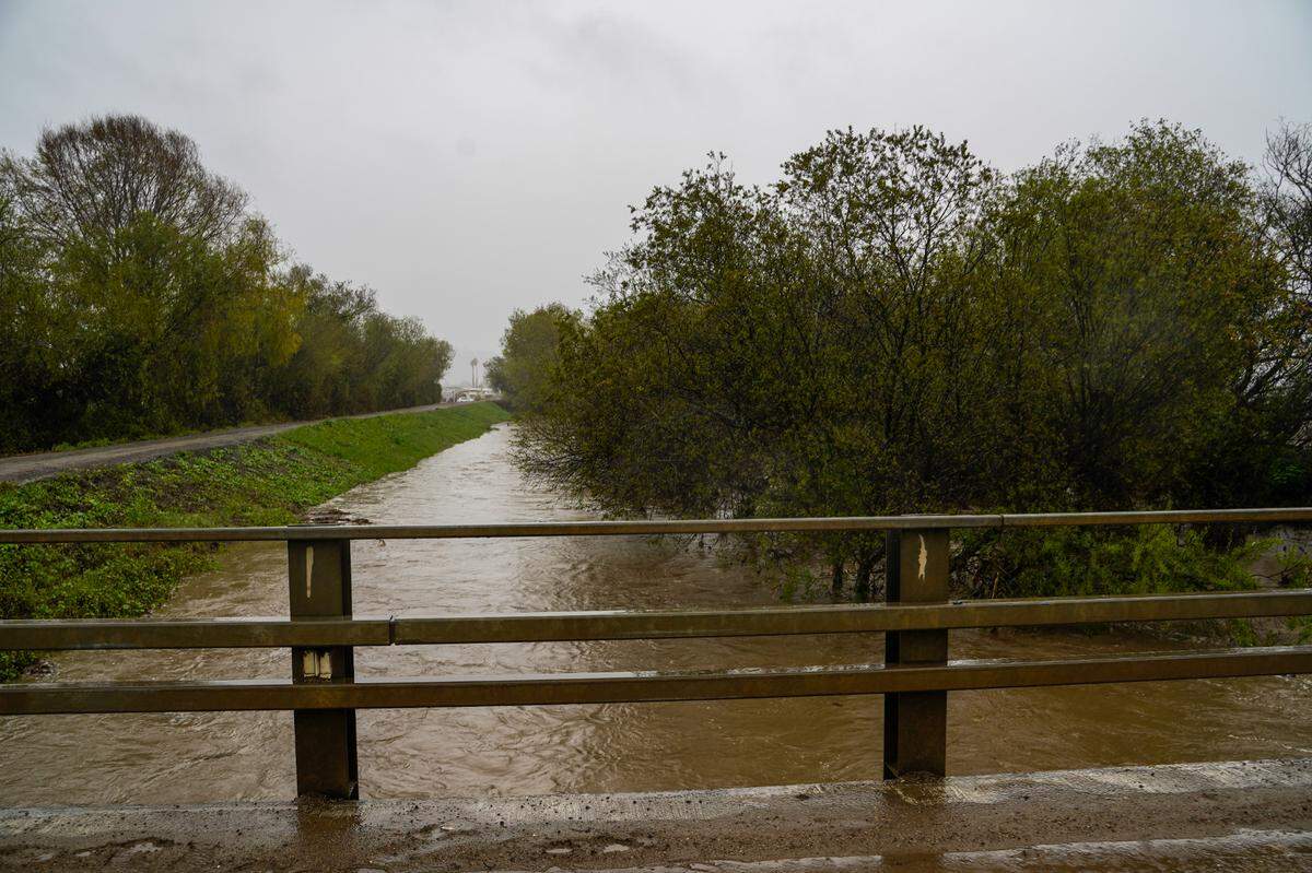 San Luis Obispo County Department of Public Works officials monitor the Arroyo Grande Creek Levee’s overflow levels on March 10, 2023.