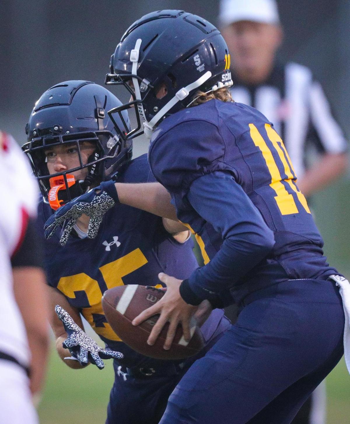 Drake Missamore hands off to Junior Herlihy in the Eagles’ 39-7 loss to Centennial of Bakersfield on Aug. 26, 2022.