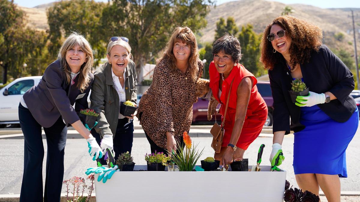 Dignity Moves chief real estate officer Joanne Price, Welcome Home Village project manager Margaret Shepard-Moore, Good Samaritan Shelter executive director Sylvia Barnard, San Luis Obispo County District 3 Supervisor Dawn Ortiz-Legg and San Luis Obispo Mayor Erica Stewart plant succulents in a 3D printed planter box at the Welcome Home Village groundbreaking on Wednesday, June 25, 2025.