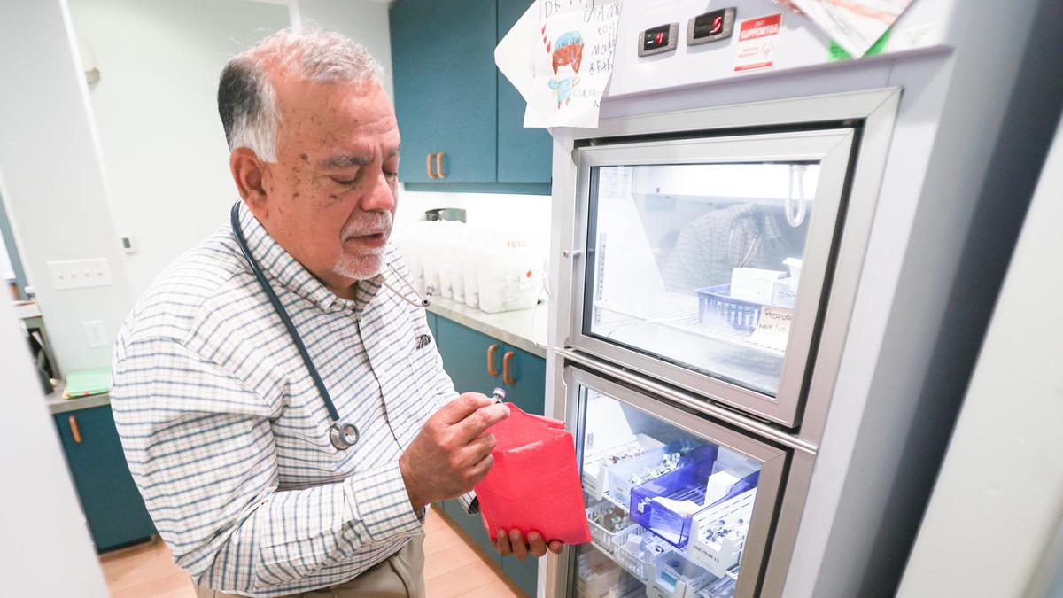 Dr. René Bravo holds a vial of the coronavirus vaccine at Bravo Pediatrics. Bravo recently began holding weekly COVID-19 shot clinics at the San Luis Obispo office.