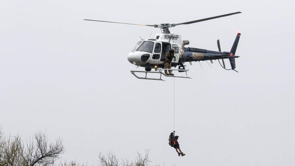 A California Highway Patrol helicopter and the Paso Robles Fire Department rescue 10 people from the Salinas River on March 22, 2018. Heavy rains and flooding are expected when a storm hits Paso Robles on Wednesday and Thursday.