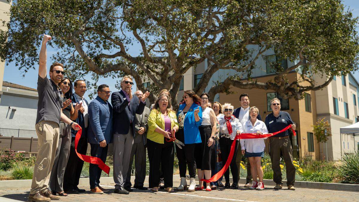 Corki Clark-Henderson cuts the ribbon at People's Self-Help Housing's grand opening for Cleaver & Clark Commons in Grover Beach on Wednesday, May 20, 2026. The first People's Self-Help Housing project in Grover Beach features 53 affordable units, with an emphasis on formerly homeless individuals and farmworker families.