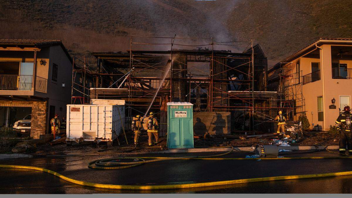 Firefighters work to extinguish a fire Tuesday afternoon at a new home under construction in the 1200 block of Costa Brava in Pismo Beach.