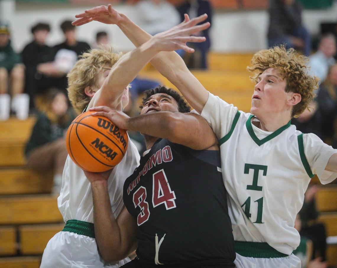 RJ Blackmon is fouled by Quincy Winkler, left. Also defending is Ryan McNamee. Nipomo boys beat Templeton 74-60 in a basketball game in Templeton Feb. 1, 2023.
