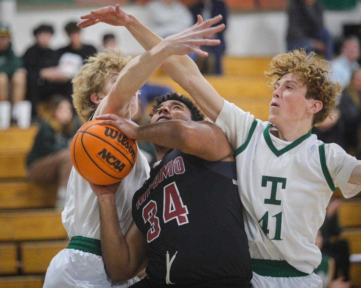 RJ Blackmon is fouled by Quincy Winkler, left. Also defending is Ryan McNamee. Nipomo boys beat Templeton 74-60 in a basketball game in Templeton on Feb. 1, 2023.